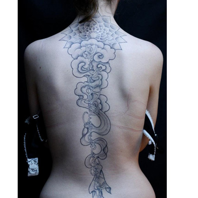 vertical cursive artistic spine tattoo